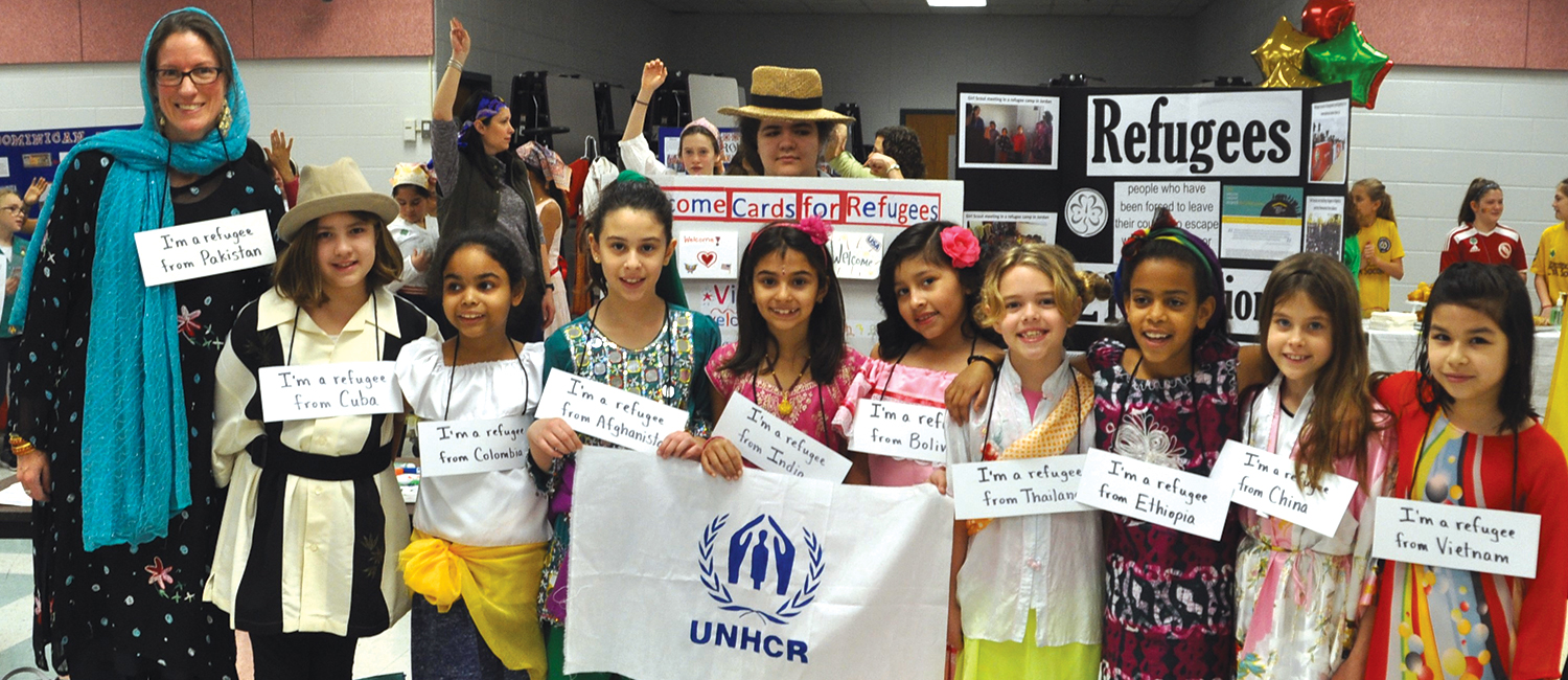  Troop 3173 holds UNHCR flag at World Thinking Day event. 