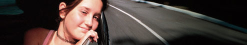 Photo of a girl looking out a car window.
