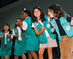 Photo of Junior Girl Scouts clapping and singing. © GSUSA. All rights reserved.