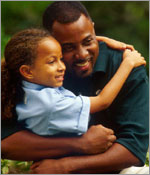 Photo of father hugging daughter. &copy; GSUSA. All rights reserved. (Photographer: Lori Adamski-Peek)