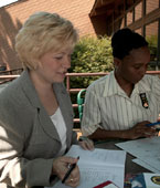 Photo of adult volunteers and staff sitting outside the Edith Macy Conference Center. &copy; GSUSA. All rights reserved. (Photographer: Quad Photo/Karineh Gurjian-Angelo/Dedjora Von Jutaz)