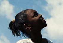 Photo of a girl lookiing up at the sky.