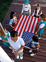 Photo of Girl Scouts preparing to raise the American flag.