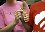 Photo of a Girl Scout helping her mother with the Girl Scout Promise and Law.