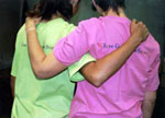Photo of a mother and daughter with arms around each other.