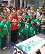 Photo of Girl Scouts standing with race car driver Sarah Fisher.