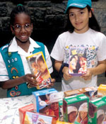 Photo of Junior Girl Scouts with cookies. &copy; GSUSA. All rights reserved.