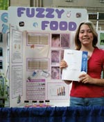 Photo of Peri displaying her science fair project.