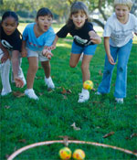 Photo of Girl Scouts tossing balls. &copy; GSUSA. All rights reserved. (Photographer: Lori Adamski-Peek)