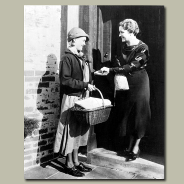 Historical photo of Girl Scout selling cookies. &copy; GSUSA. All rights reserved.