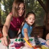 Photo of girl and adult painting. © GSUSA. All rights reserved. (Photographer: Quad Photo/Karineh Gurjian-Angelo/Dedjora Von Jutaz)