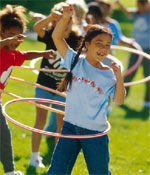Photo of girls with hula hoops. &copy; GSUSA. All rights reserved. (Photographer: Lori Adamski-Peek)