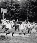 Historic photo of Girl Scouts exercising. © GSUSA. All rights reserved.