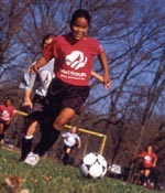 Color photo of today's Girl Scouts playing soccer. © GSUSA. All rights reserved.