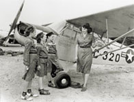 Photo of Girl Scouts standing in front of an airplane. © GSUSA. All rights reserved.