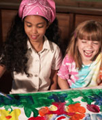 Photo of two Girl Scouts painting.