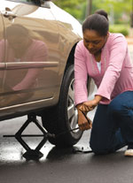 Photo of girl changing tire.