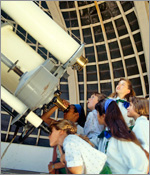 Photo of girls looking through a telescope.