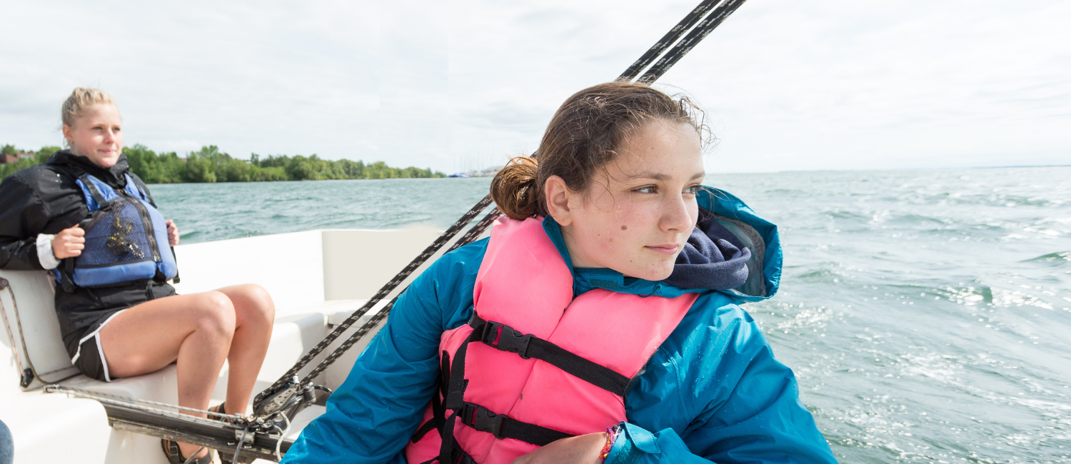 girl wearing a lifejack on a boat
