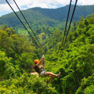 a girl zip lining in the jungle