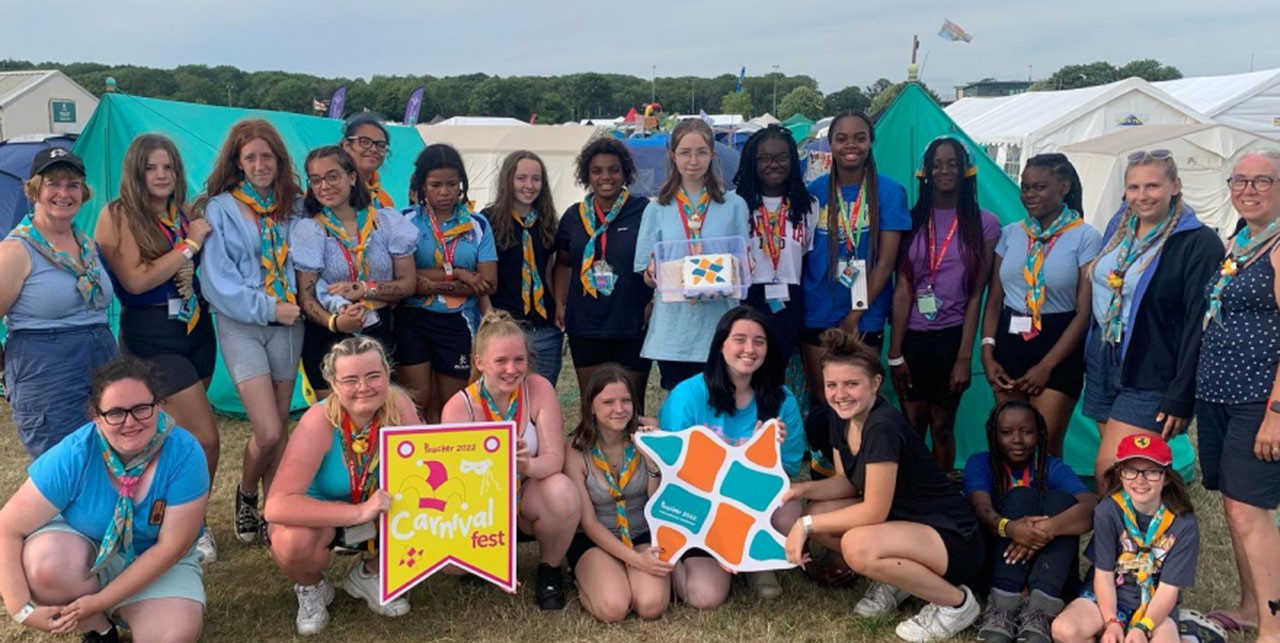 group of teen girls and adults wearing scouting scarves