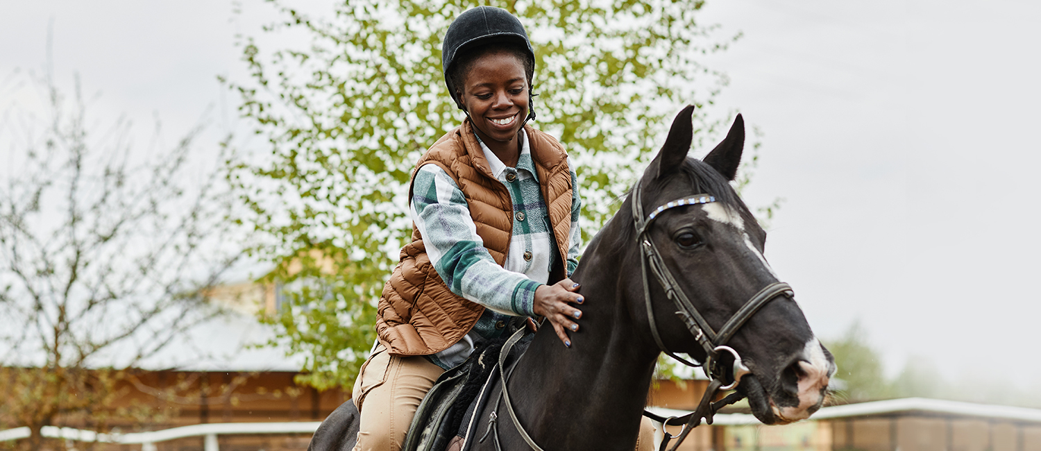 teenage girl riding a horse