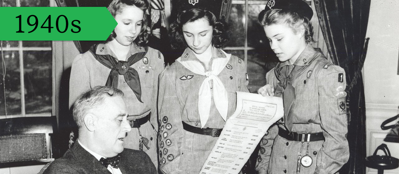Girl Scouts present President Franklin Delano Roosevelt with a checklist documenting service hours, March 12, 1944.