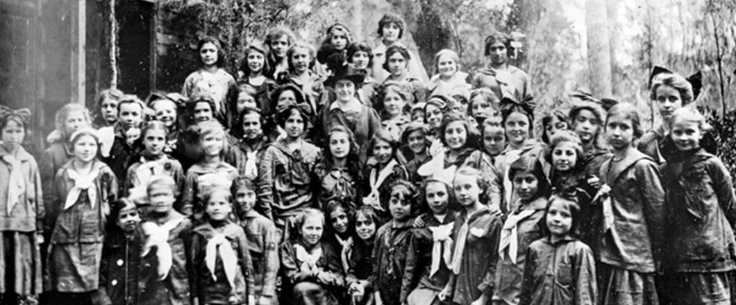  Vintage photo of Juliette Gordon Low "Daisy" with a large group of girls in vintage Girl Scout uniforms, the first Girl Scout troop. 
