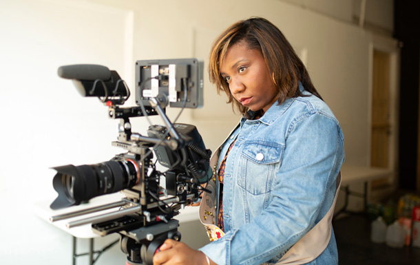 high school senior girl scout ambassador using professional video camera for filmmaking content creation for teens