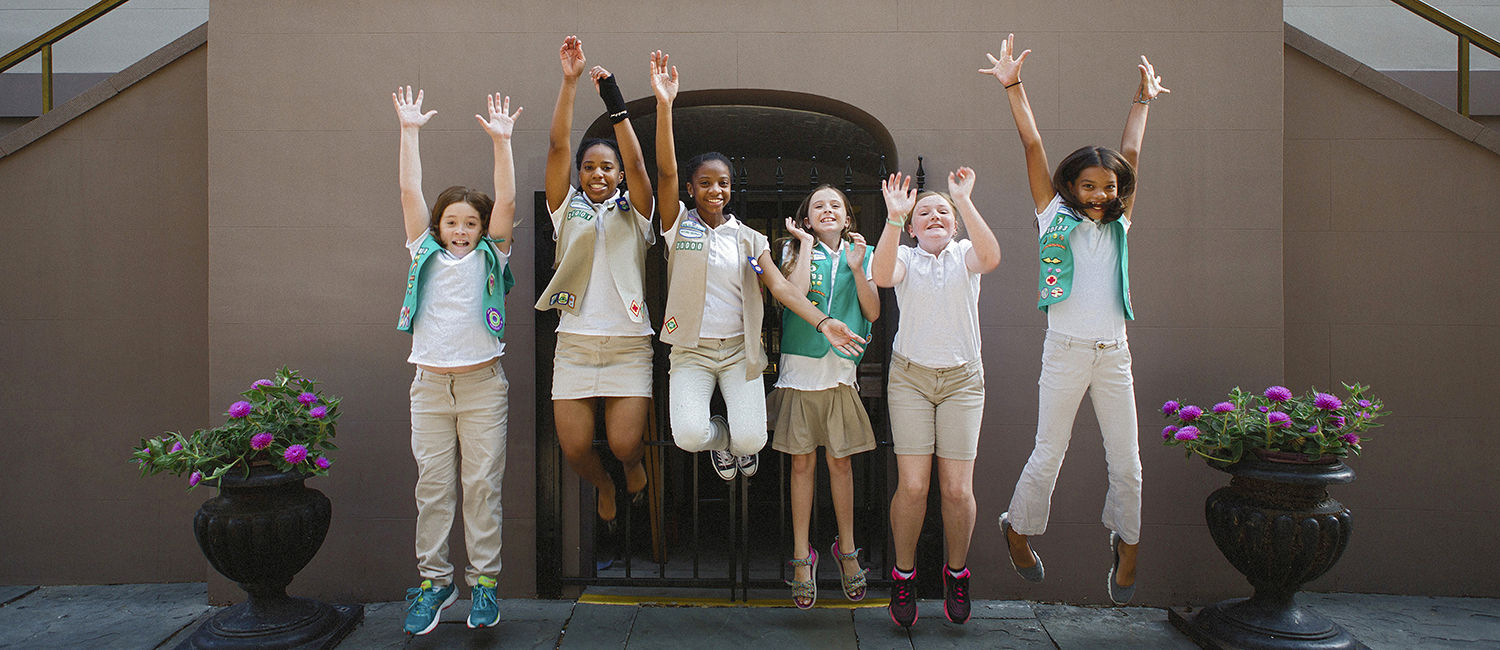  Troop of Junior Girl Scouts jumping outside the entrance to the Juliette Gordon Low Birthplace 