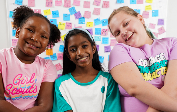Four Junior Girl Scouts sitting outdoors playing games