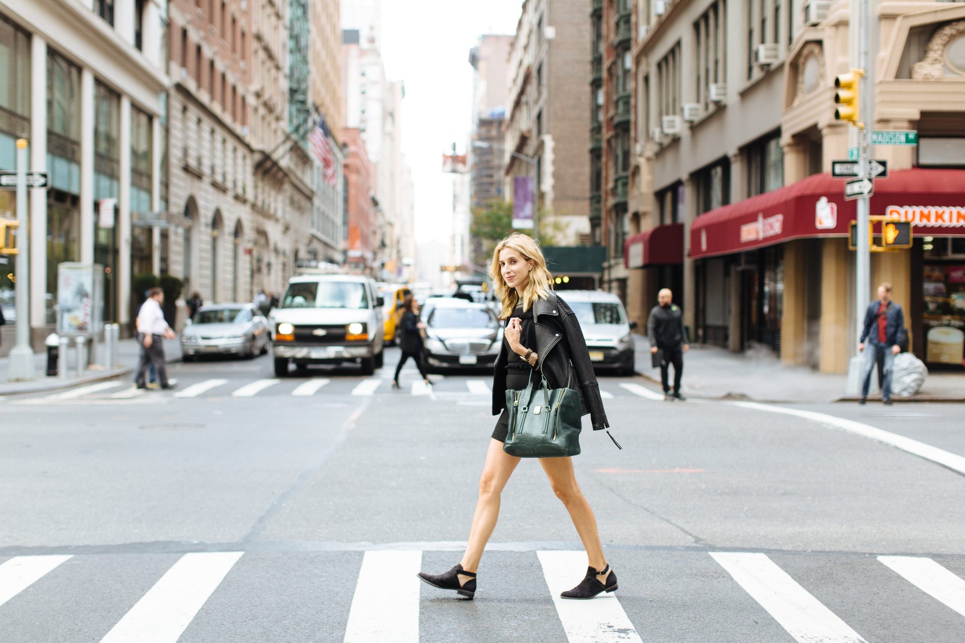  Katia Beauchamp crossing a city street at a crosswalk 