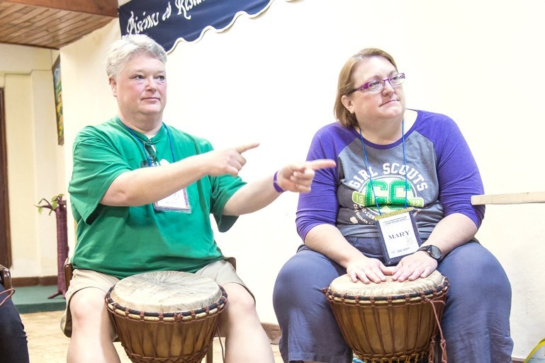 Lori and long-time Girl Scout friend Mary learn to play the drums at the Kusafari World Centre in Africa in 2017.