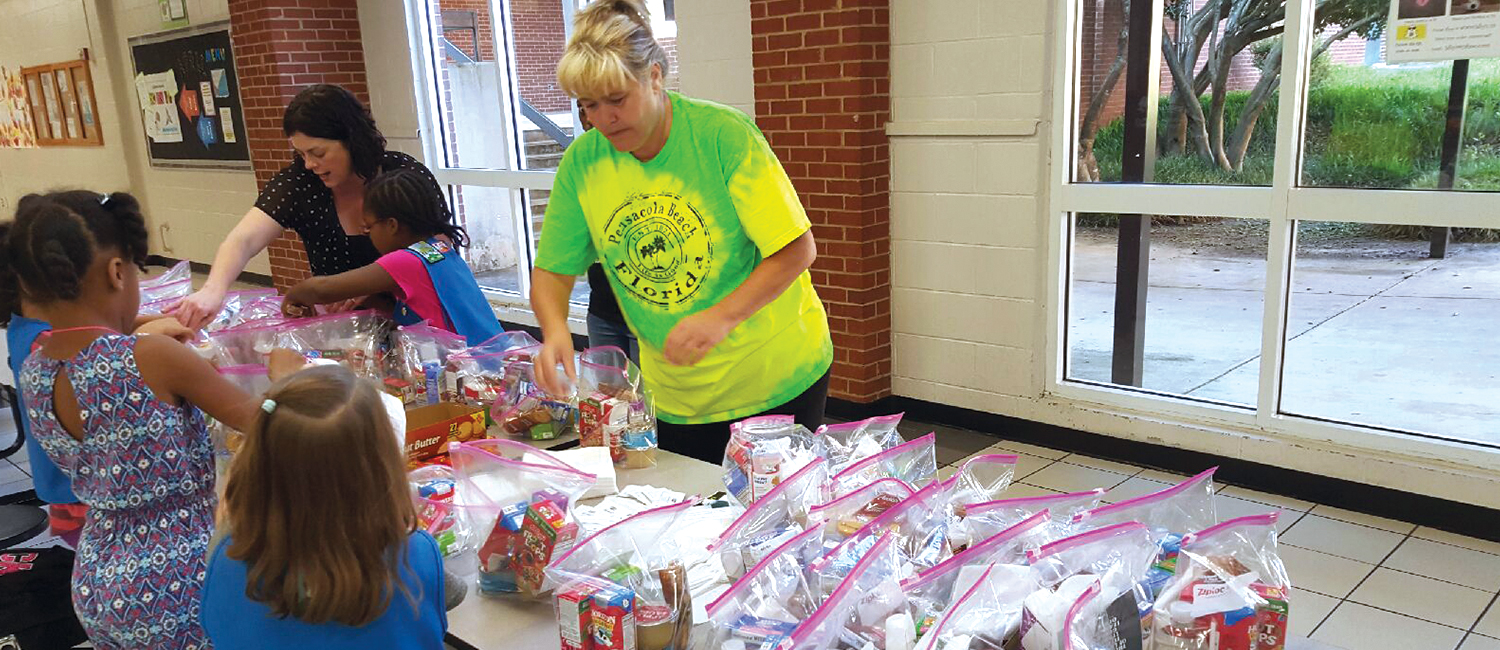  Girl Scouts assembling care packages for the homeless 