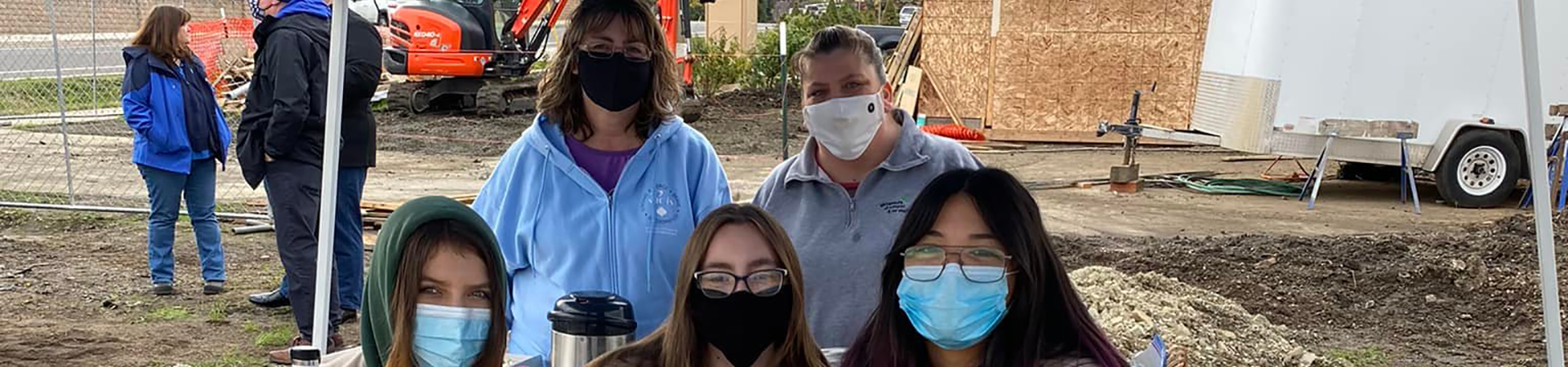  Troop  30021 wearing masks in a group photo at a job site 