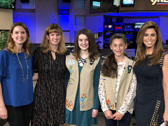Kathleen Moreira, Kristen Batcho, and Girl Scouts Makenna and Julianna smile for the camera after being interviewed by 9News morning anchor Cory Rose about the girls' Silver Award project. 