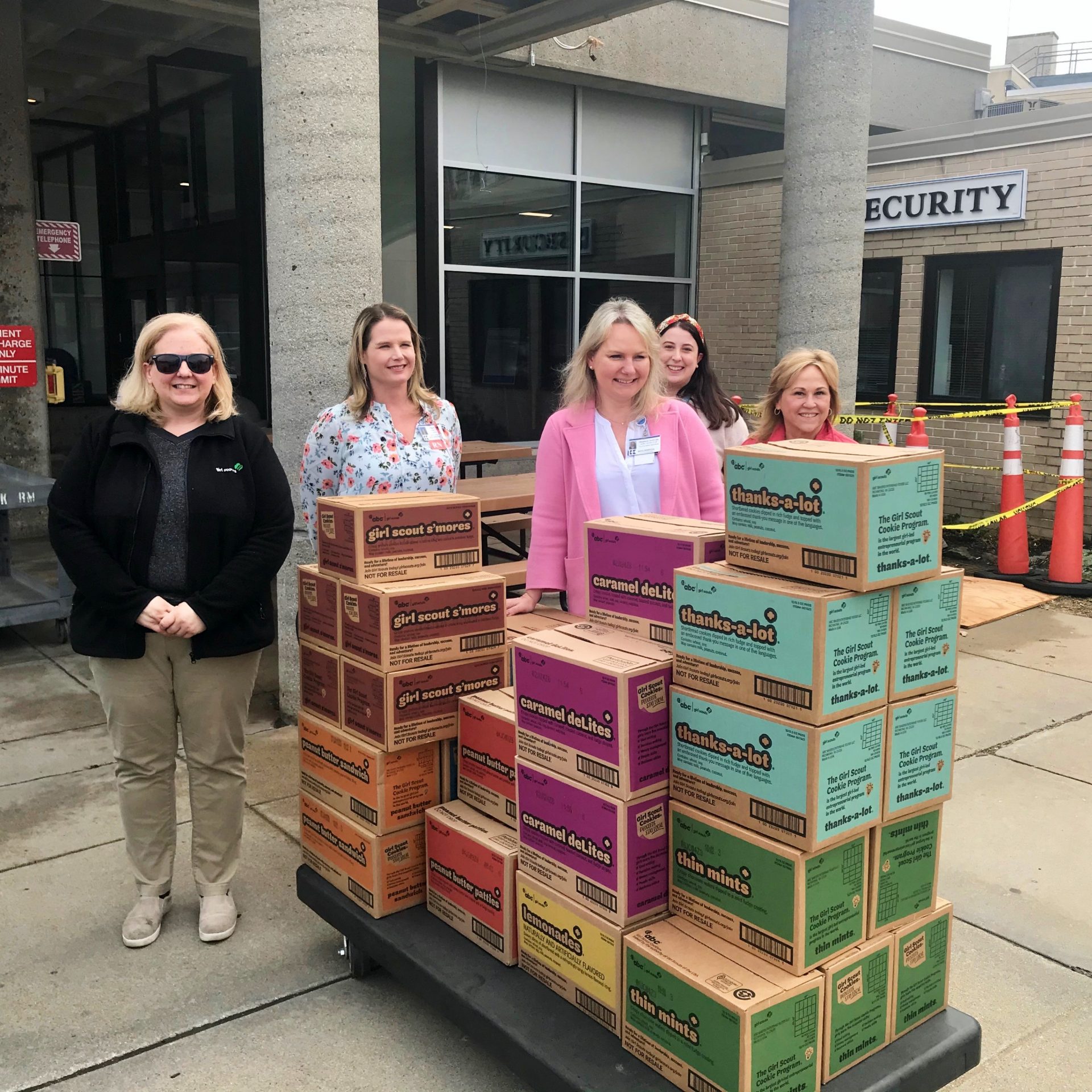 group of hospital staff members with palates of Girl Scout Cookies