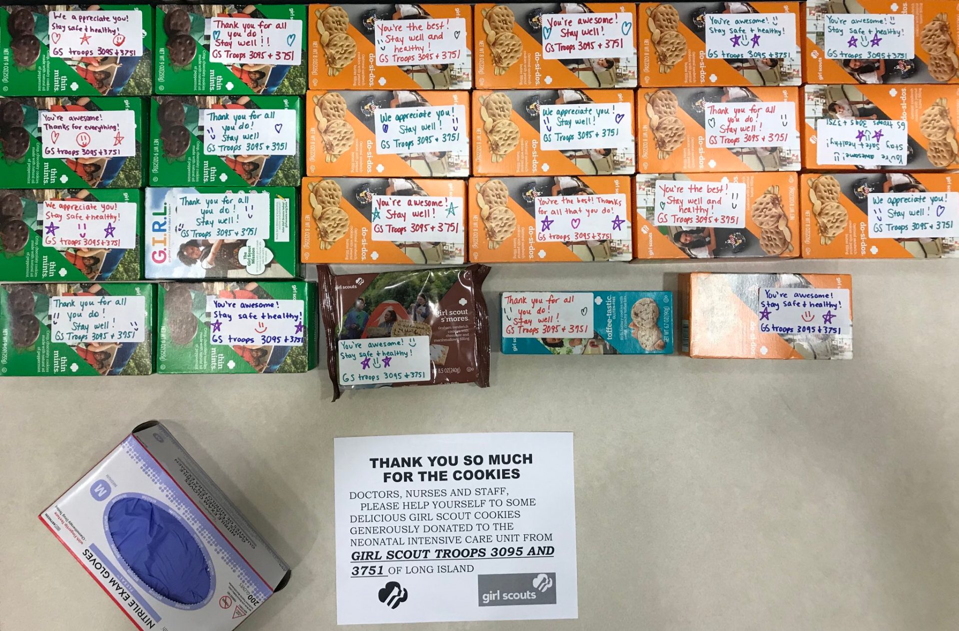 Boxes of Girl Scout Cookies with notes from Girl Scouts to hospital staff members