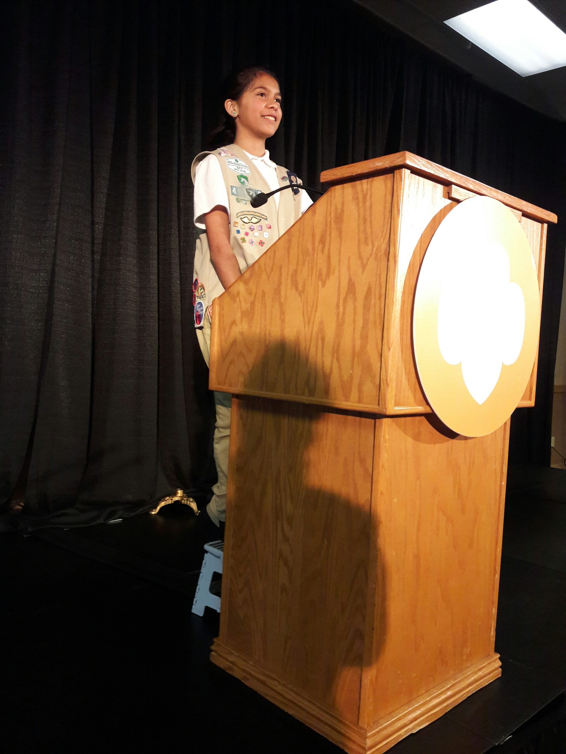 Taylor speaks at the podium about bullying and how Girl Scouts inspired her to be brave during Girl Scouts Heart of Central California's annual meeting in Sacramento.