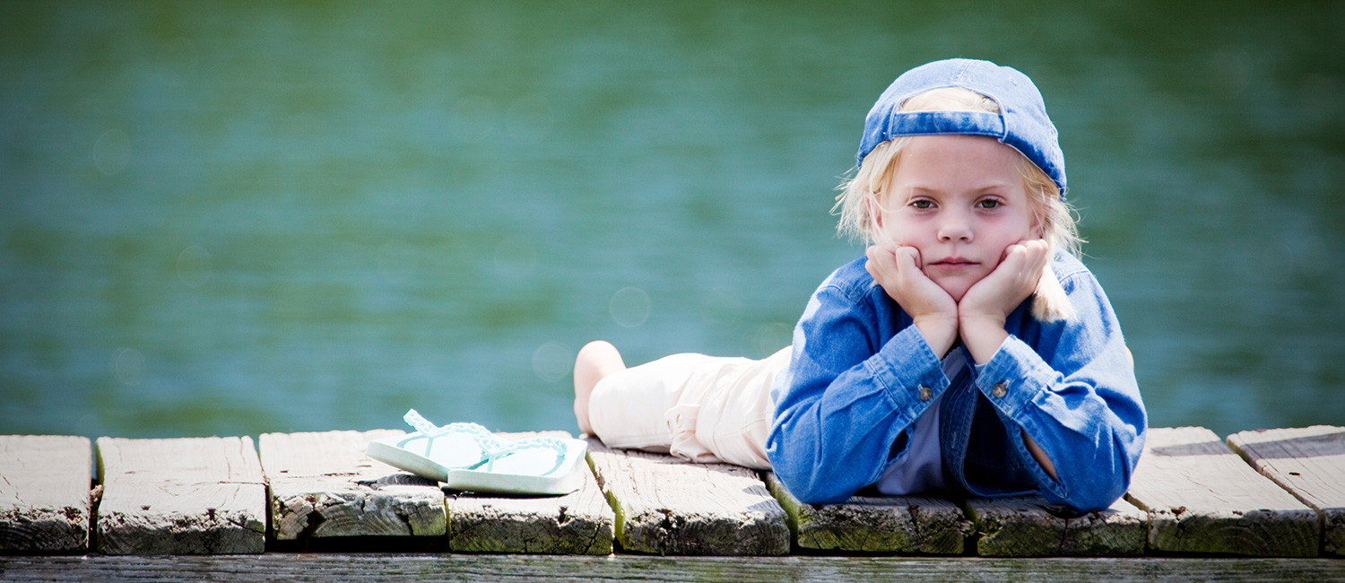  Young girl on a dock at summer camp. 
