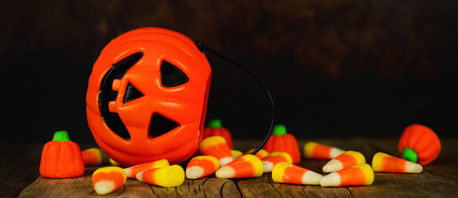  Spilled Halloween candy from a jack-o-lantern after trick-or-treating. 