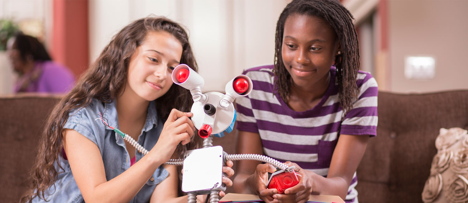  High school girls work on robot for education for a STEM project. 